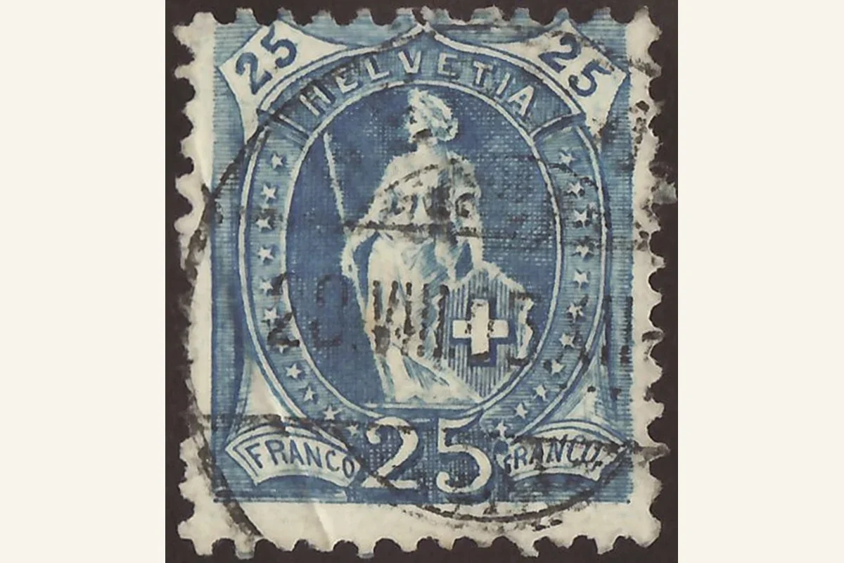 Genuine used blue 25-rappen Standing Helvetia stamp with an oval figure, cross shield and heavy cancellation