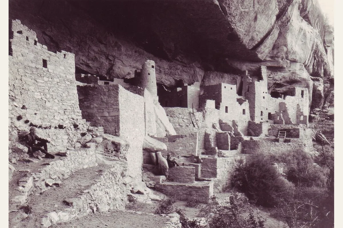 George A. Grant historical photograph of Cliff Palace at Mesa Verde with park rangers among the ruins