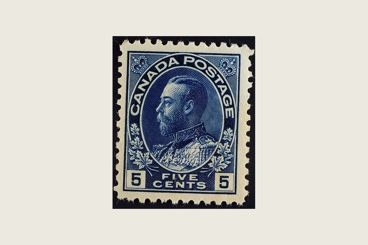 Genuine blue Canadian five-cent Admiral stamp with George V in naval uniform and CANADA POSTAGE inscription