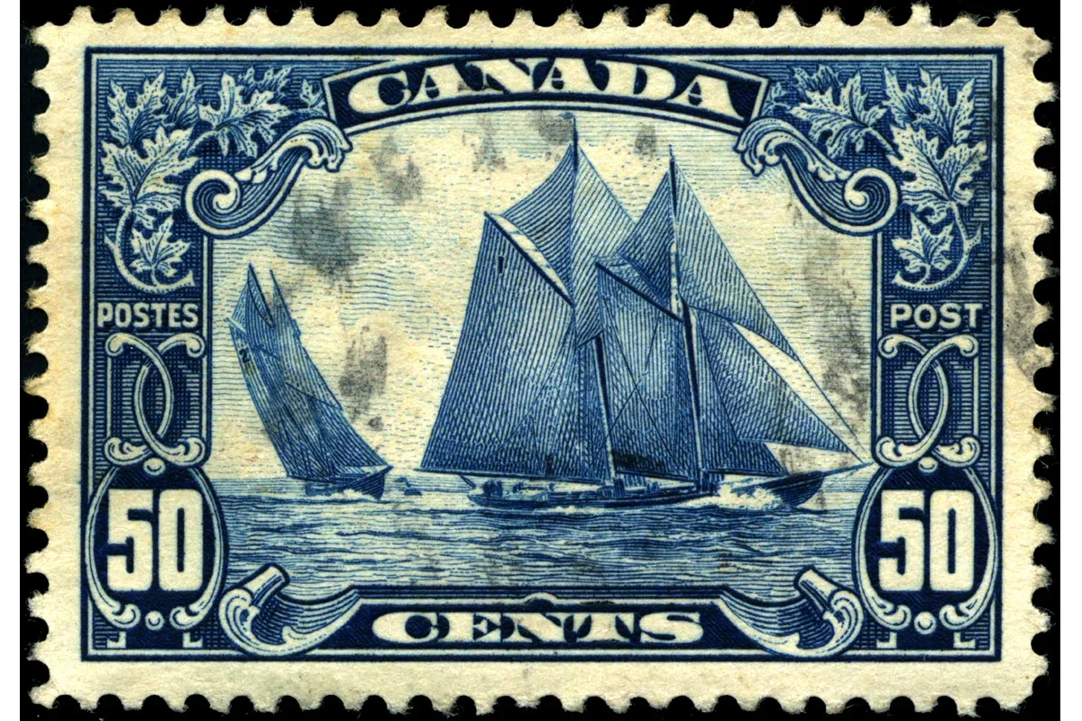 Genuine used Canadian 1929 dark-blue 50-cent Bluenose stamp showing the schooner and complete frame